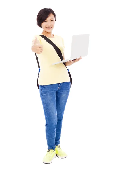 Smiling young woman holding a laptop and thumb up — Stock Photo, Image