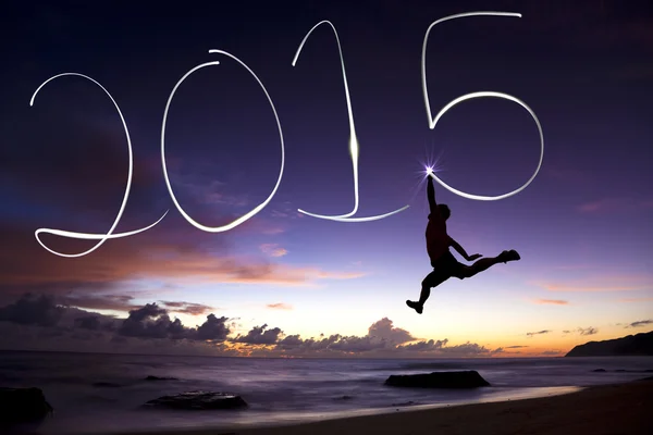 Happy new year 2015.young man jumping and drawing 2015 — Stock Photo, Image