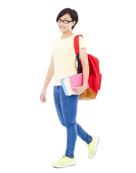 Sonriente joven estudiante chica de pie y sosteniendo libro — Foto de Stock