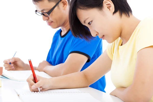 Two young students learning together in classroom — Stock Photo, Image