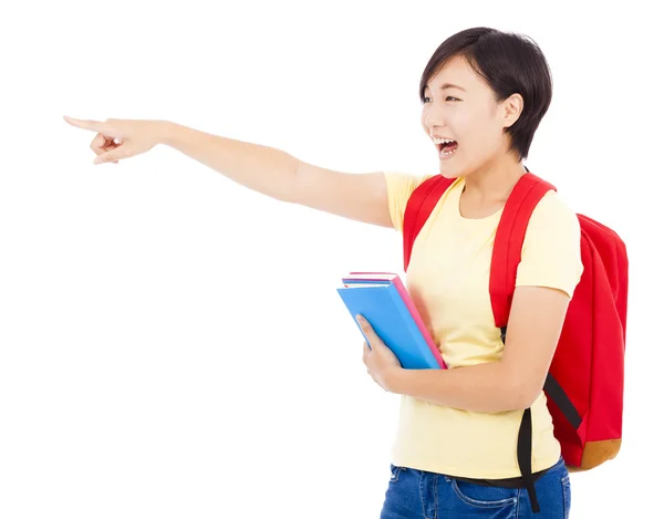 Estudante feliz menina segurando livro e apontando — Fotografia de Stock