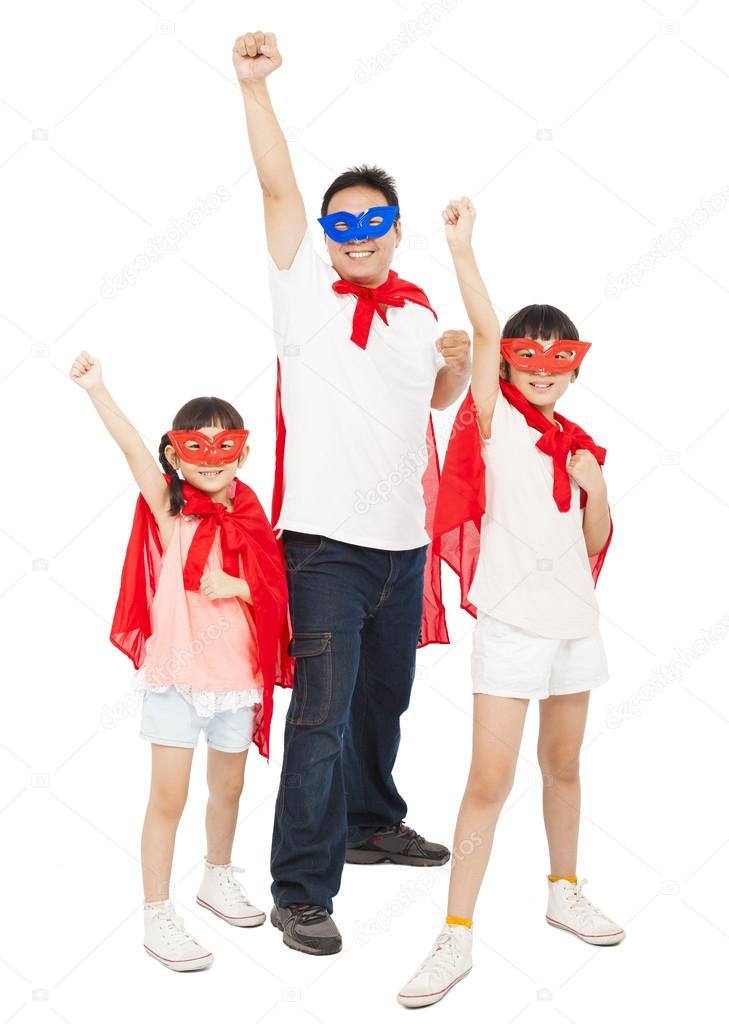 Father and daughters making a superhero pose with red cape