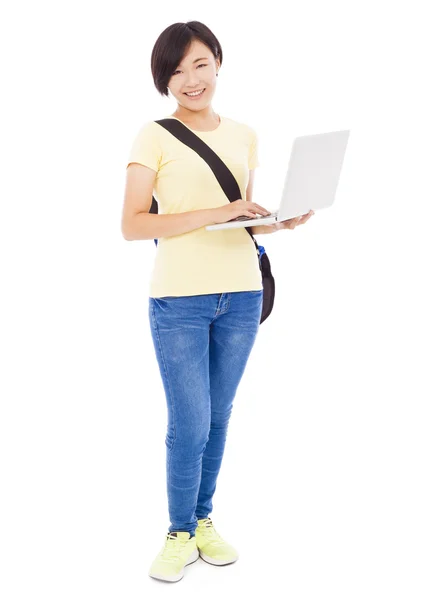 Smiling young woman holding a laptop over white background — Stock Photo, Image