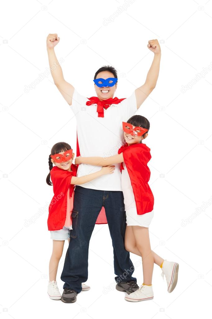 Superhero daughters hug father waist. isolated on white