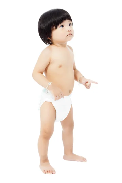 Cute baby girl in a diaper standing and looks up isolated on whi — Stock Photo, Image