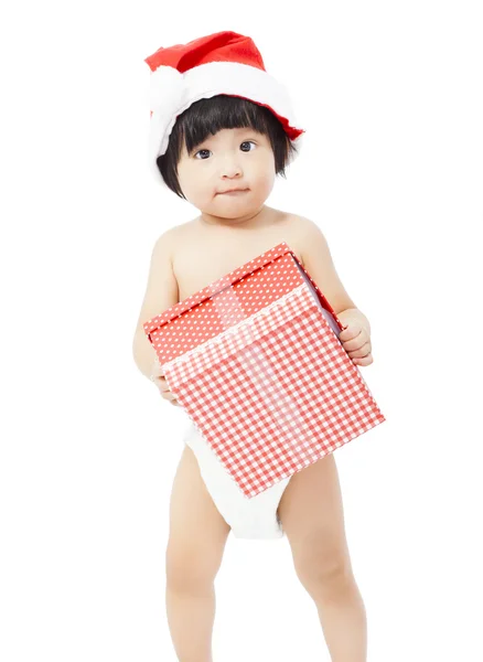 Niedliches Baby in Weihnachtsmannmütze mit einer Geschenkbox — Stockfoto