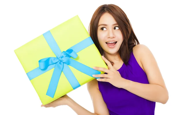 Happy young woman holding a gift box over white background — Stock Photo, Image