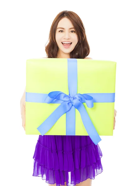 Happy young woman holding a gift box over white background — Stock Photo, Image