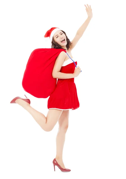 Jovem fêmea segurando um saco de presente com terno de Natal correndo e — Fotografia de Stock