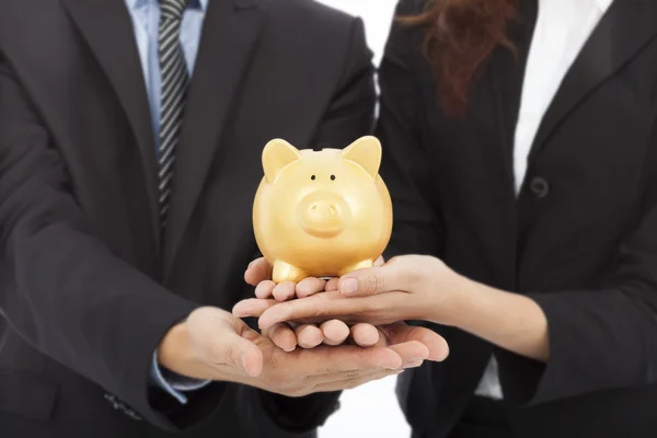 Hands of business people holding a piggy bank .financial concept — Stock Fotó