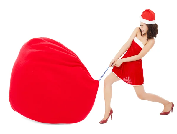 Young female pulling a heavy and big gift bag — Stock Photo, Image