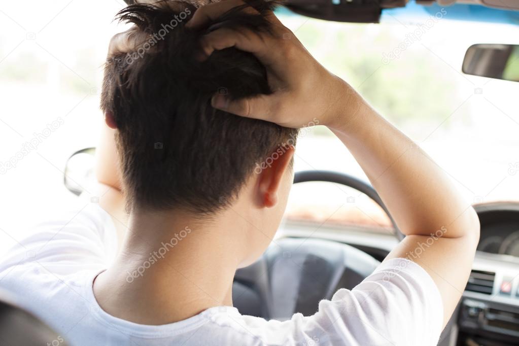  young man have a big trouble while driving car.
