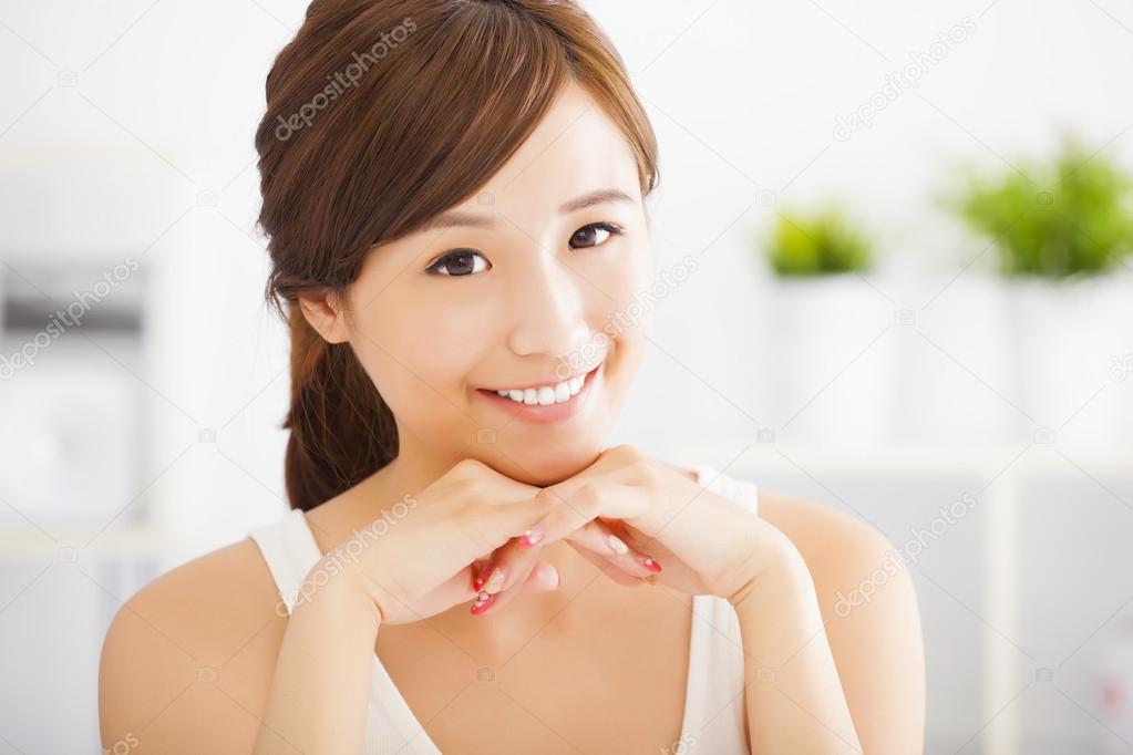 close up of beautiful and smiling  asian young woman at home