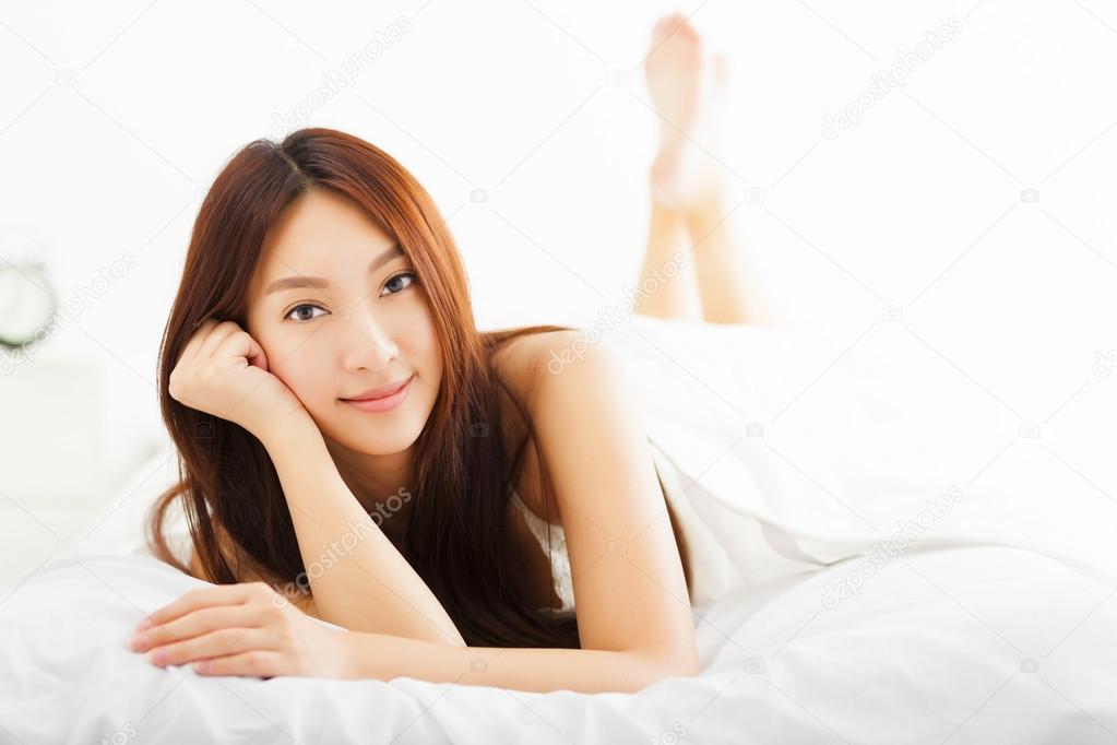 young Beautiful woman relaxing on the bed