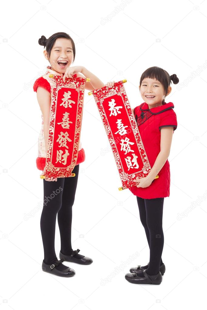  asian little girls showing couplets for happy chinese new year