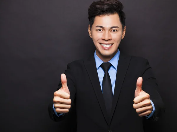 Smiling asian businessman with thumbs up — Stock Photo, Image