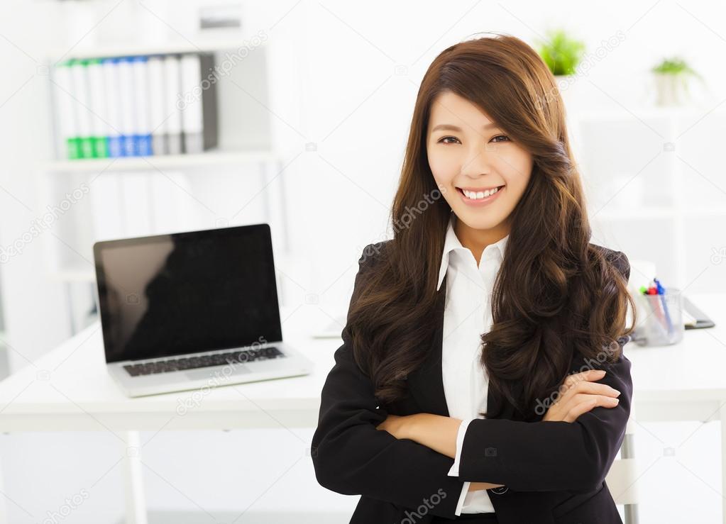 happy young business woman working in the office