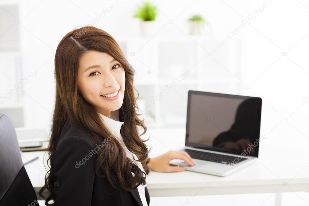 happy young business woman working in the office