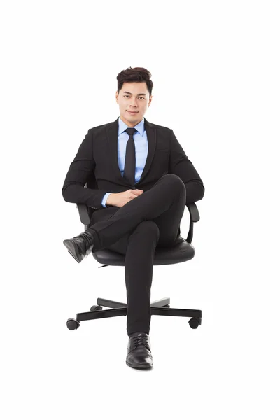 Young businessman sitting in a chair — Stock Photo, Image