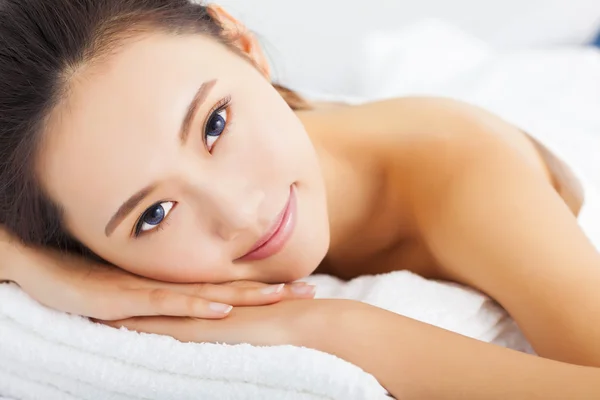 Young  smiling woman getting spa treatment over white background — Stock Photo, Image