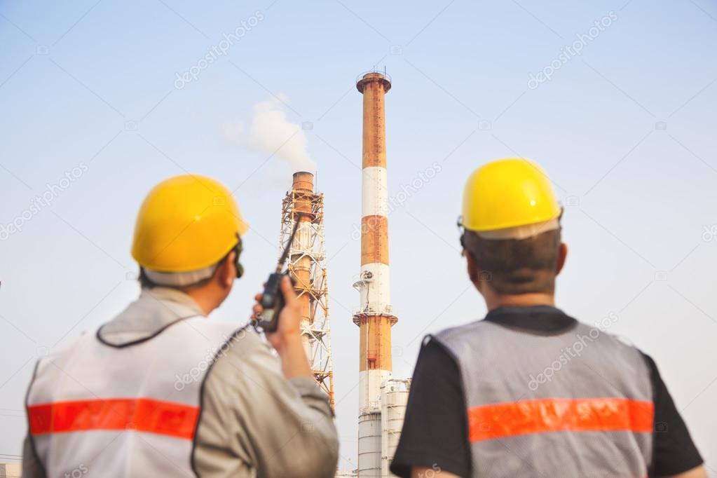 refinery workers discussion and pointing for inspection