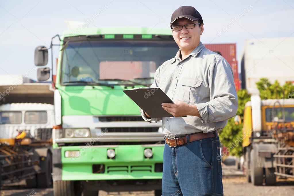 happy truck driver writing on a document