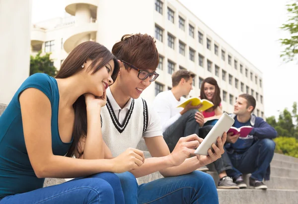 Joven pareja estudiante usando la tableta — Foto de Stock