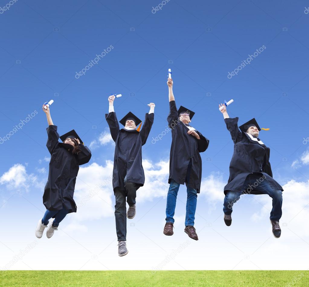 Happy young group of graduation students jumping together