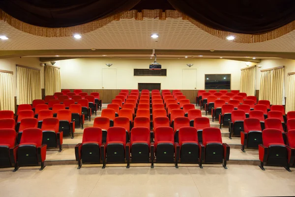 Interior of empty conference hall with red chairs — Stock Photo, Image