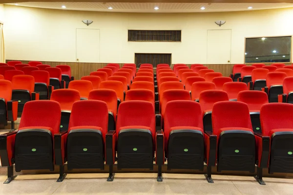 Interior of empty conference hall with red chairs — Stock Photo, Image