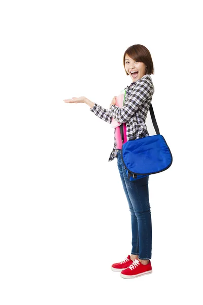 Young happy student with books and showing something — Stock Photo, Image