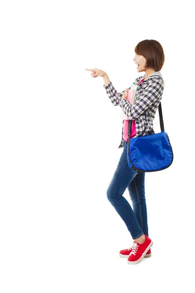 Young happy student with books and pointing something — Stock Photo, Image