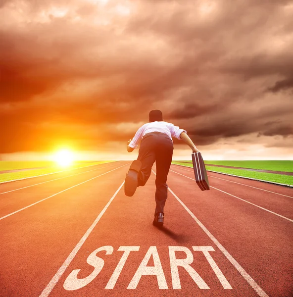 Businessman running for race on the track — Stock Photo, Image