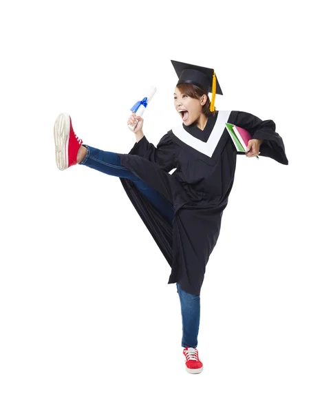 Happy kvinnlig student i graduate robe dans — Stockfoto