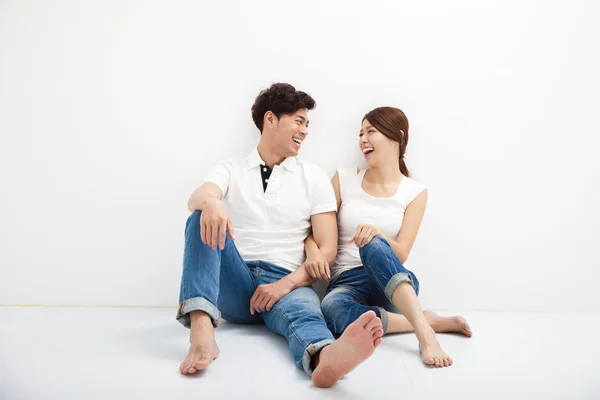 Feliz jovem ásia casal sentado no chão — Fotografia de Stock