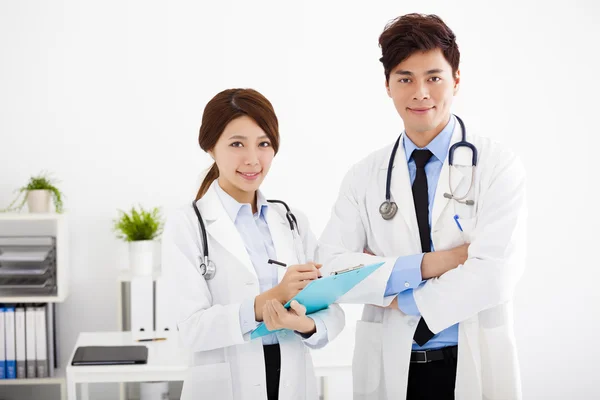 Male and female medical doctors working in a hospital office — Stock Photo, Image