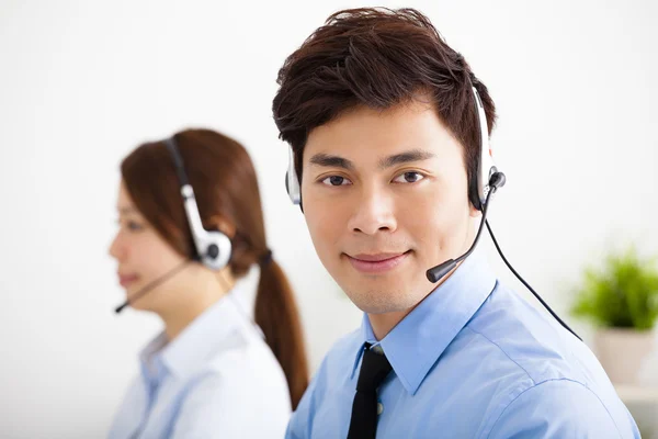 Hombre de negocios y mujer de negocios con auriculares trabajando en la oficina — Foto de Stock