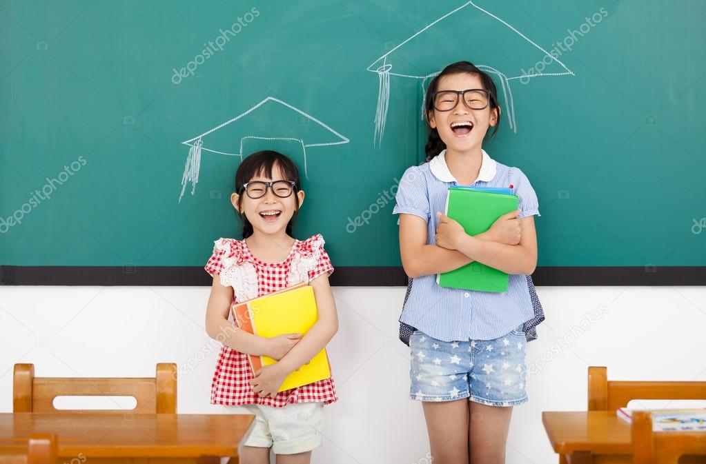 happy little girls with graduation concept in classroom