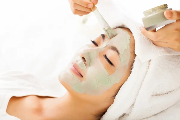 Young beautiful woman with clay facial mask — Stock Photo, Image