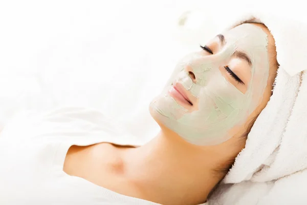 Young beautiful woman with clay facial mask — Stock Photo, Image