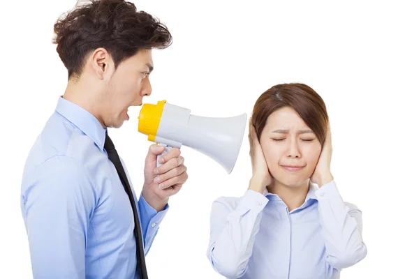 Businessman using megaphone to scream at businesswoman — Stock Photo, Image