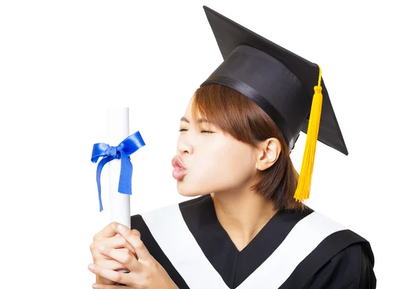 Happy young woman graduating kissing diploma — Stock Photo, Image