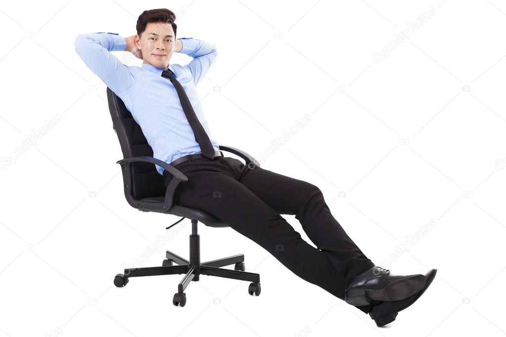 relaxed Young businessman sitting in a chair isolated