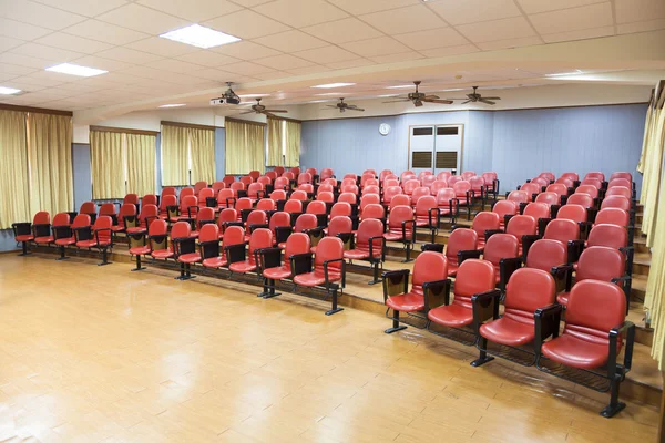 Interior of empty conference hall with red chairs — Stock Photo, Image