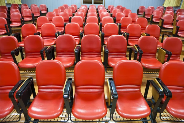 Interior of empty conference hall with red chairs — Stock Photo, Image