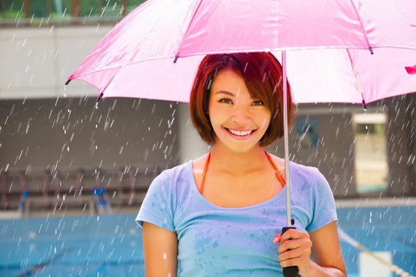 Beautiful young woman under pink umbrella — Stock Photo, Image