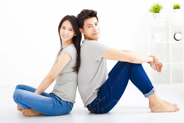 Young happy couple sitting together — Stock Photo, Image