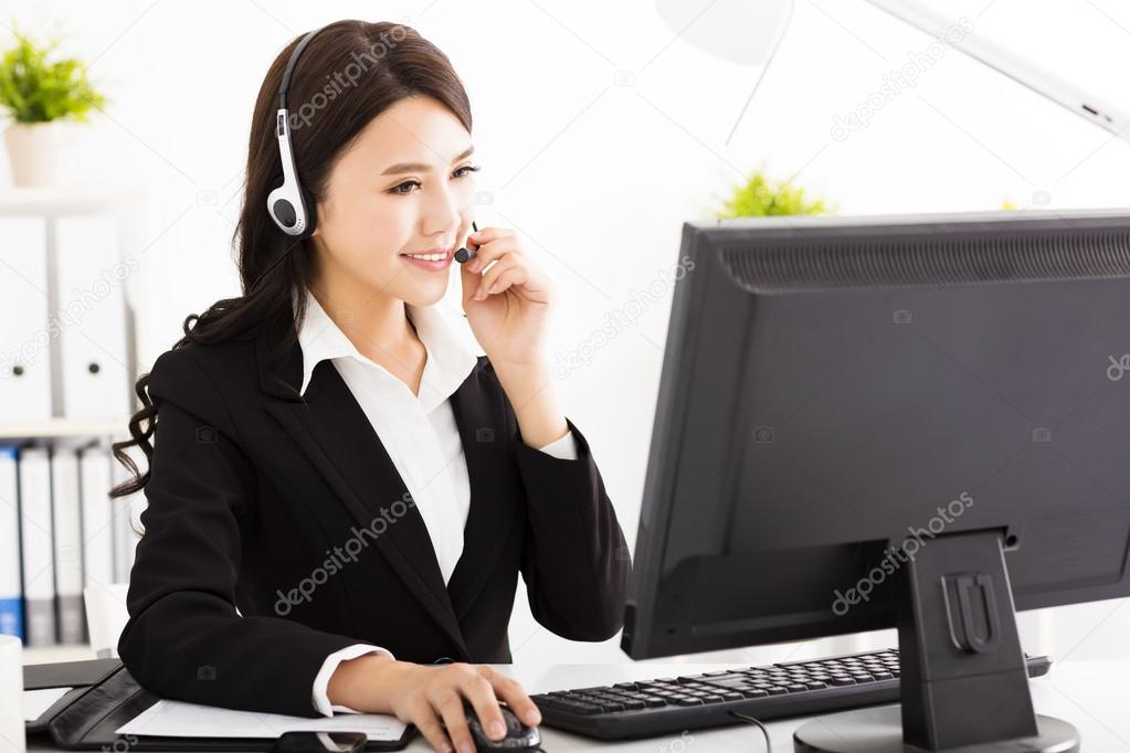 Young beautiful  business woman with headset in office