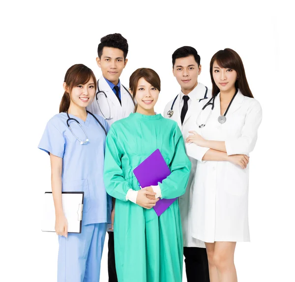 Sonriente equipo médico de pie juntos aislados en blanco — Foto de Stock