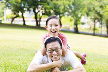 mutlu baba ve küçük kız çim üzerinde yalan